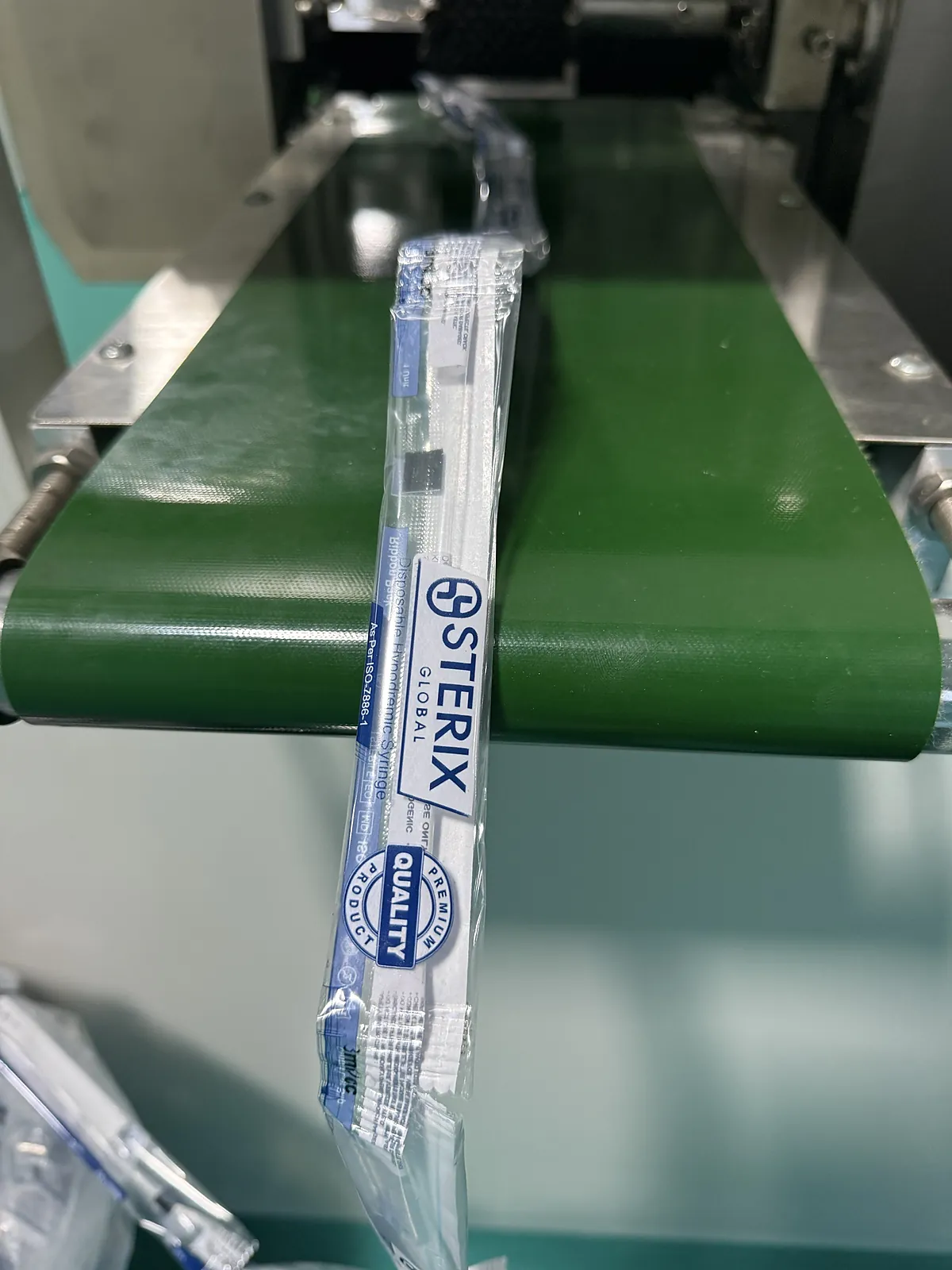 Syringe sealed in its printed ribbon pack on the packing line